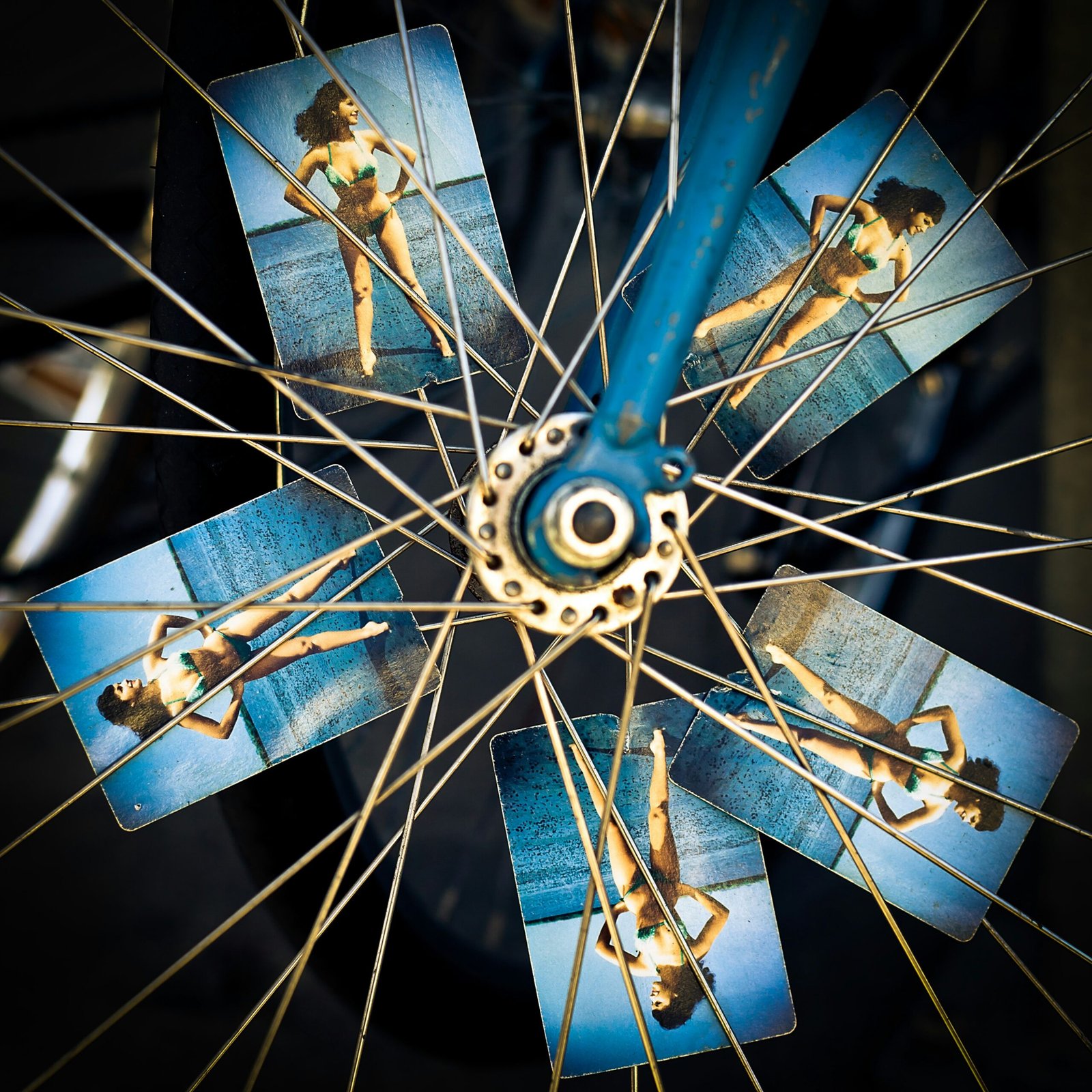 blue and grey bicycle wheel with photo of woman